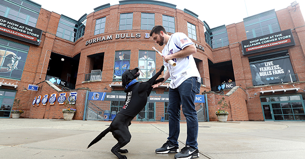 dog and trainer at Durham Bulls Park
