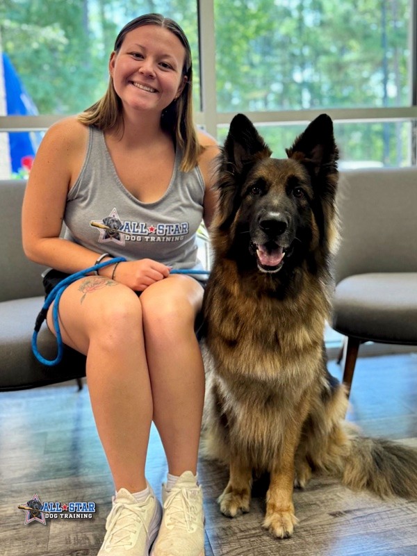 All-Star Dog Training Staff smiling with german shepard
